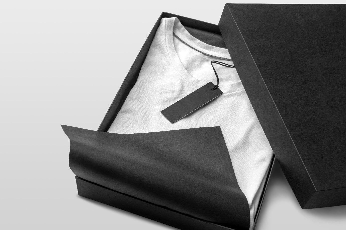 Black Boxed Packaging with White T-Shirt Inside with Black Tag